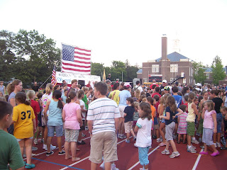 Children gather to run a lap with Olympian Erin Donohue