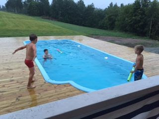 Kids playing in garden swimming pool