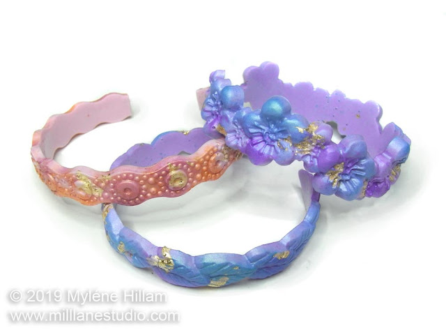 Stack of 3 textured bangles in shades of pink-orange and purple-blue.