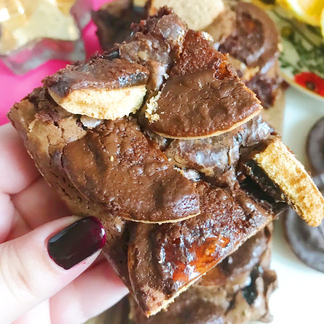 Jaffa cake brownie held up in front of others on chopping board