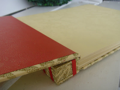 The end sheet has a faint print of roses in gold Used a red satin ribbon to