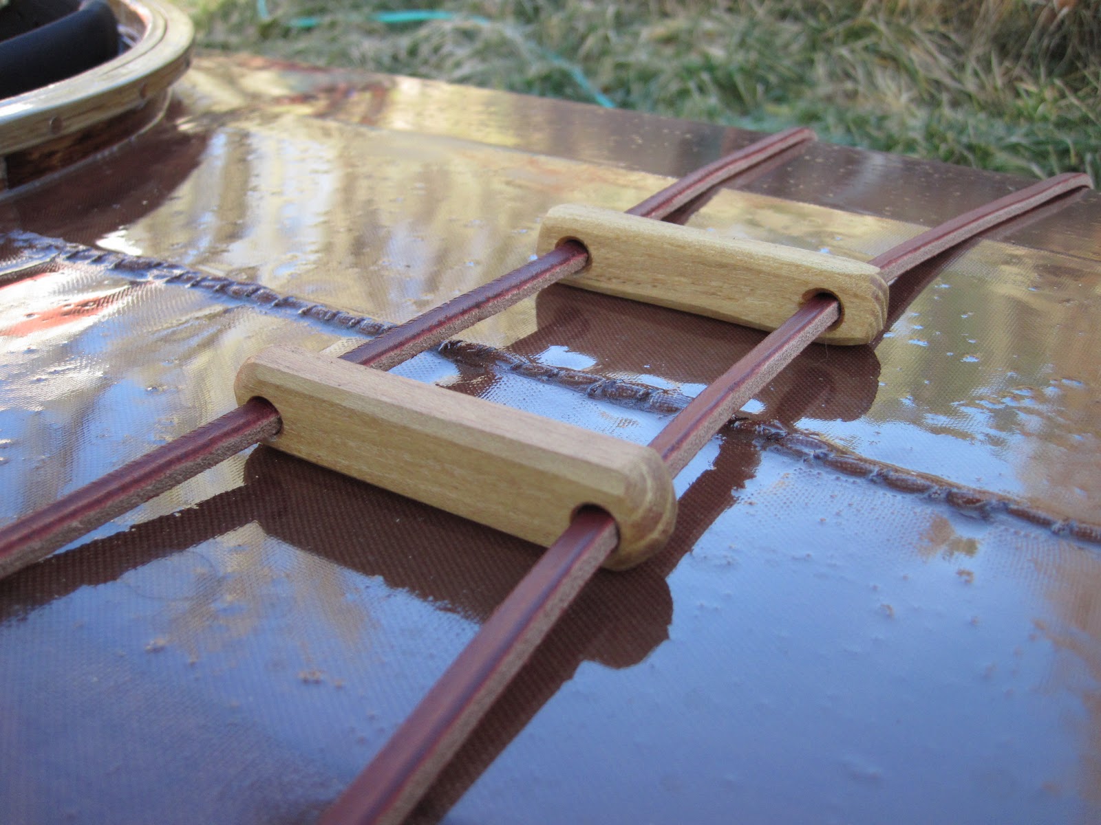 Deck line detail. Straps are thick latigo leather. Toggles are oiled ...