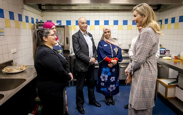 Queen Maxima wore a check belted trench coat by Massimo Dutti, and Massimo Dutti culotte fit checked trousers