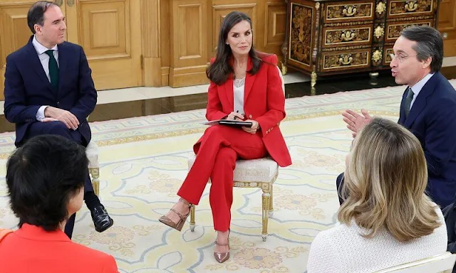 Queen Letizia wore a fuchsia, pink, red blazer suit by Carolina Herrera. Patrizia Pepe pumps, Gold and Rose earrings