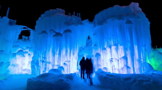 Visitors outside one of the castles at night. - What Happens To This New England Town Every Winter Is So Beautiful, It's Shocking