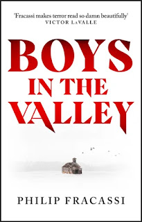 Book "Boys in the Valley" by Philip Fracassi. Against a whited out background a small wooden cabin sits in front of a treelined. Above the title, the words "Fracassi makes terror read so damn beautifully - Victor LaValle".