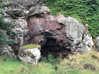 A closer view of the entrance to St Baldred's Cave with the altar stone standing in front of it.  Photograph by Kevin Nosferatu for the Skulferatu Project.