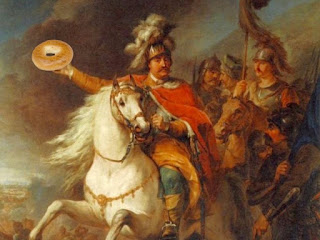 a classical looking painting of soldiers on horseback, with one holding a bagel