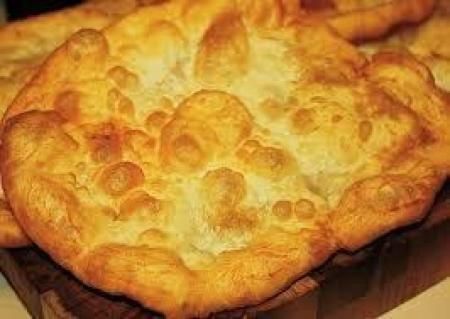 Navajo Fry bread my family's favorite. topped with Pinto Beans lettuce tomatoes and cheese