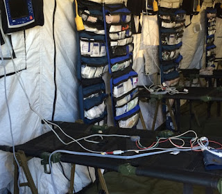 Photo of the inside of a military triage tent from The Humanitarian Village