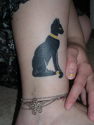 Black ink Cat Tattoo on Girls Leg