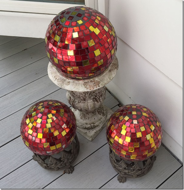 3 red mosaic gazing globes on deck