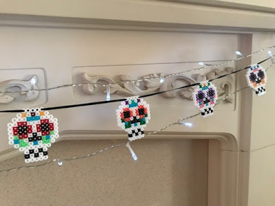 Hama bead sugar skull bunting on fireplace