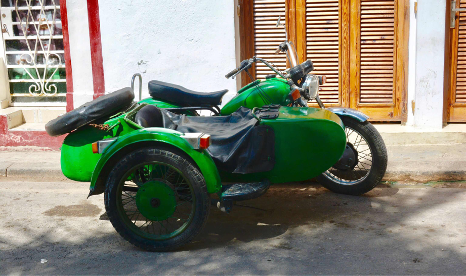 Old motorcycle and sidecar on Havana Street Cuba