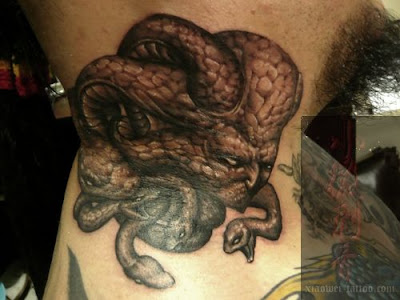 A kinda gross tattoo design with several snake heads.