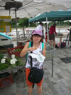 A photo of me (before amputation) eating something at a French market.