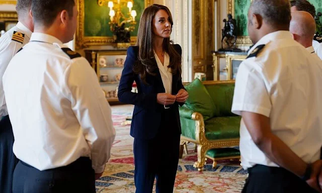 Kate Middleton wore a blue trouser suit by Alexander McQueen. Alexander McQueen leaf crepe single breast blazer