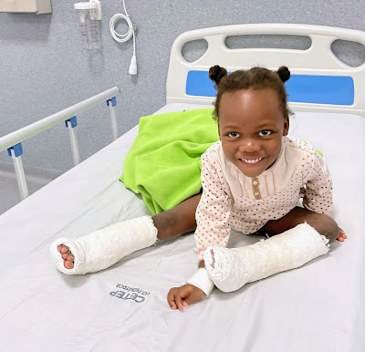 A smiling girl in a hospital in Angola following his surgery by the International Extremity Project.