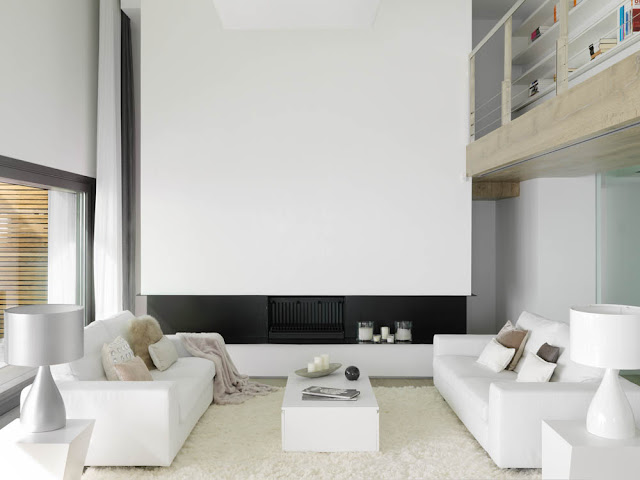Two white sofas by the fireplace 