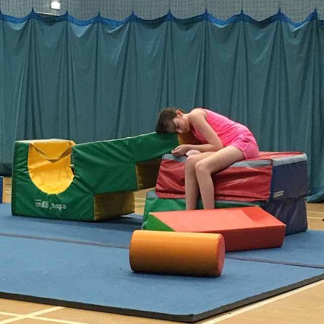 sasha sitting in middle of soft play area, sad