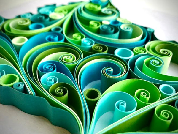 paper quilling scroll design (detail) in shades of blue and green