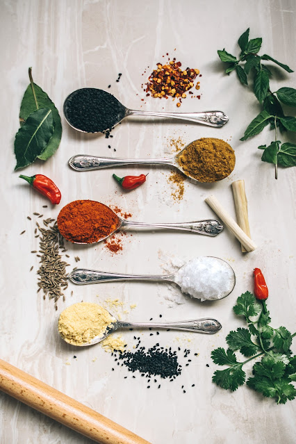 herbs & spices on silver spoons on white background;Photo by Calum Lewis on Unsplash