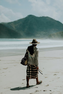 A Sasak man walks along Kuta Beach Mandalika