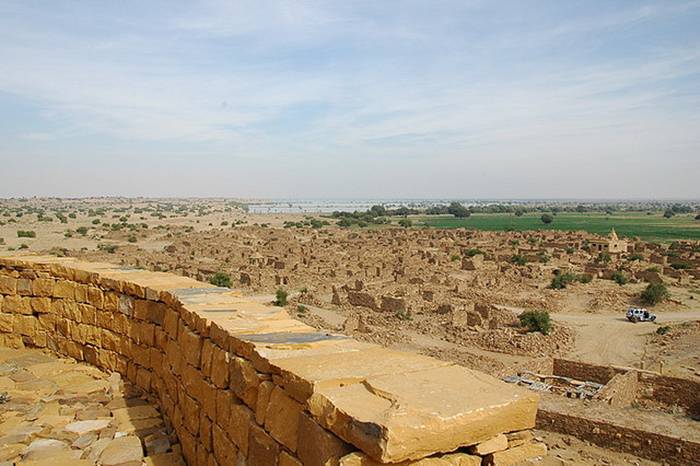 Kuldhara village near Jaisalmer has a very unique history! It is said that the residents of 84 neighboring villages including Kuldhara vacated the villages overnight around 170 years back!! No one is sure where they have gone, but they are believed to have migrated to a place somewhere near Jodhpur. The residents were Paliwal Brahmans — said to be very intelligent, and residing there for about 500 years. So what made them do such an act? Stories say that the ruler of these villages pounded the Paliwals with heavy taxes and treated them very inhumanly; the ruler was unethical and forceful to them. They had no alternative, but to vacate all the 84 villages overnight and just disappear from the vision and reach of the ruler.  When the Paliwals left the villages, they left a curse that nobody can inhabit the villages ever. Residents of Jaisalmer say that there have been some attempts by some families to stay there, but they did not succeed.