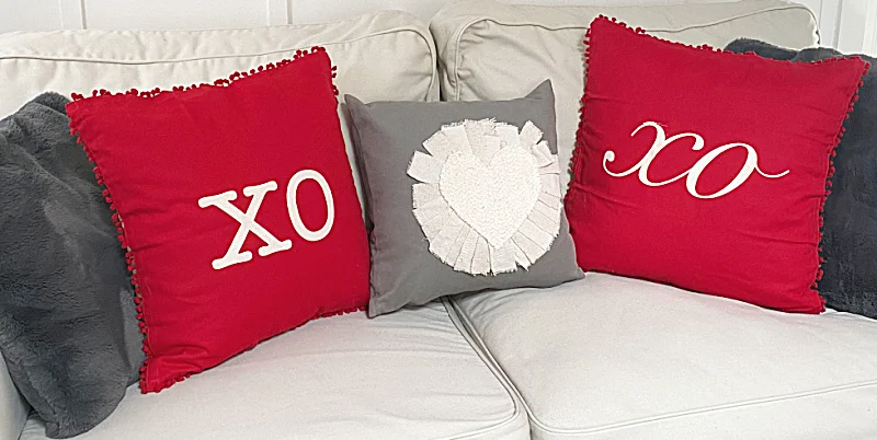 xo pillows on white sofa