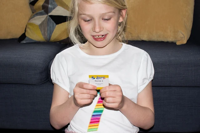 A girl reading a question card from 5 second rule jr.