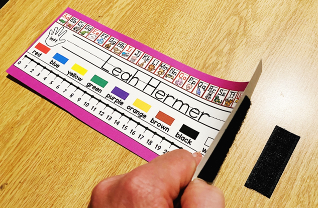 Use velcro strips to easily attach name tags to desks.  Lift to clean underneath