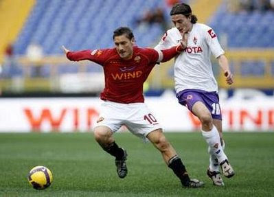 AS Roma skipper Francesco Totti fights for the ball with Riccardo Montolivo of Fiorentina