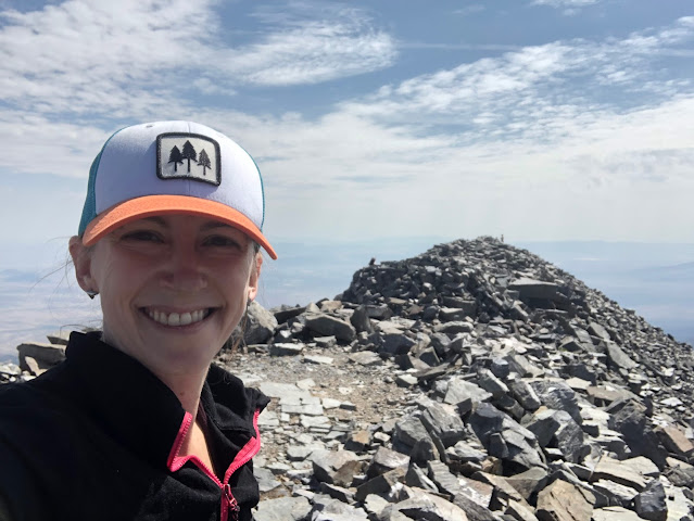 woman on top of a mountain