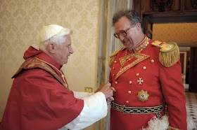 Pope Benedict XVI speaks with the new Grand Master of the Knights of Malta, Matthew Festing of Britain, during their meeting at the Vatican