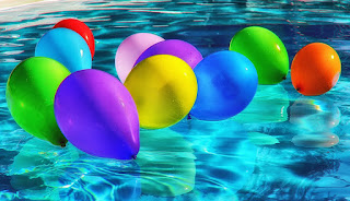 party balloons floating in a swimming pool