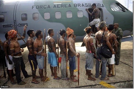 Munduruku Indians, many of whom are flying for the first time, board a Brazilian Air Force plane to fly to Brasilia, Brazil, for talks with the government, in Altamira, June 4 - Copy