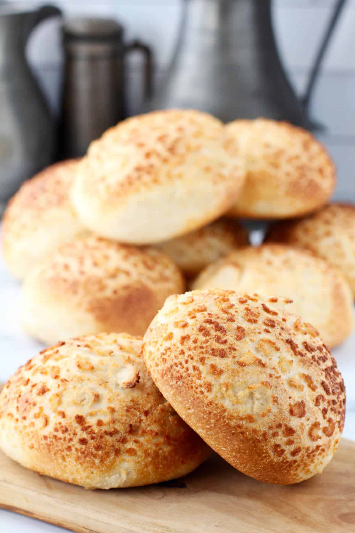 Tiger Bread Rolls stacked on a cutting board.