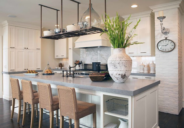 pot rack over island exposed white brick 