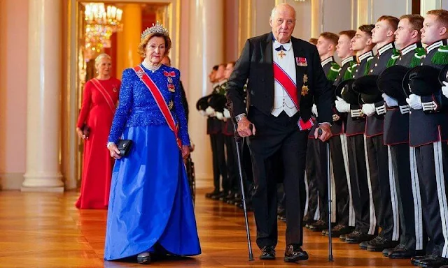 Crown Princess Mette-Marit wore a wool and silk blend red maxi dress by Valentino. Queen Sonja wore a royal blue gown