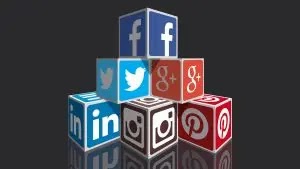 social media marketing icons of facebook linked in twitter pinterest and google+ stacked up in dark background