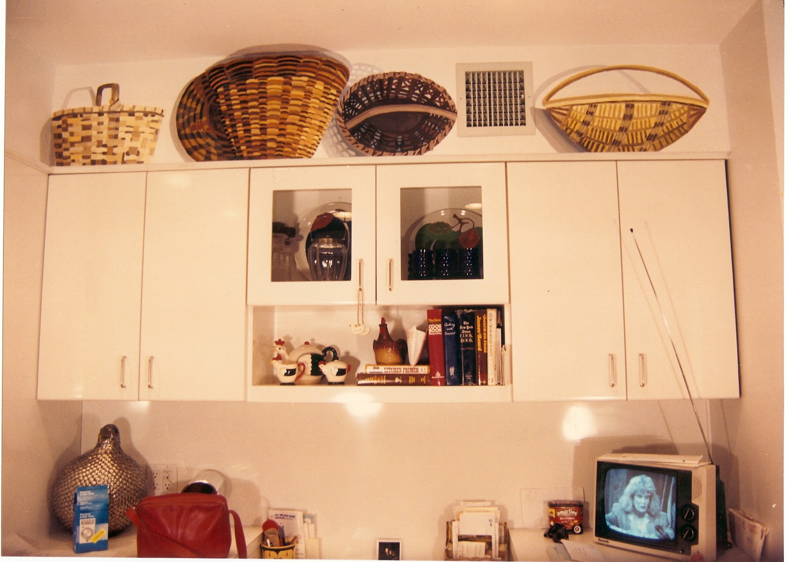 These baskets on top of the kitchen cabinets, with their shadowing and ...