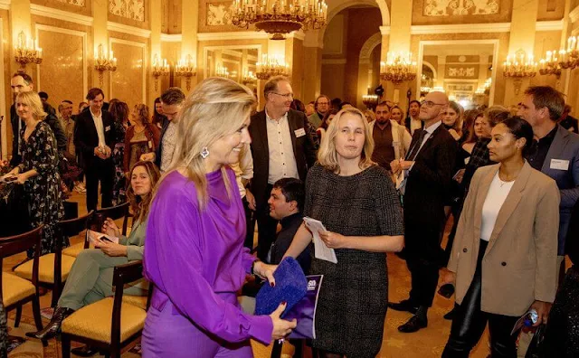 Purple silk blouse and purple trousers. JAR Paris amethyst and diamond earrings. Natan coat. Christian Louboutin purple pumps