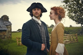 Demelza stands looking at Ross Poldark outside Nampara in season 1