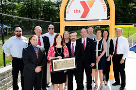 A community group photo of representatives of Rockland Trust, the Hockomock Area YMCA and the town of Franklin