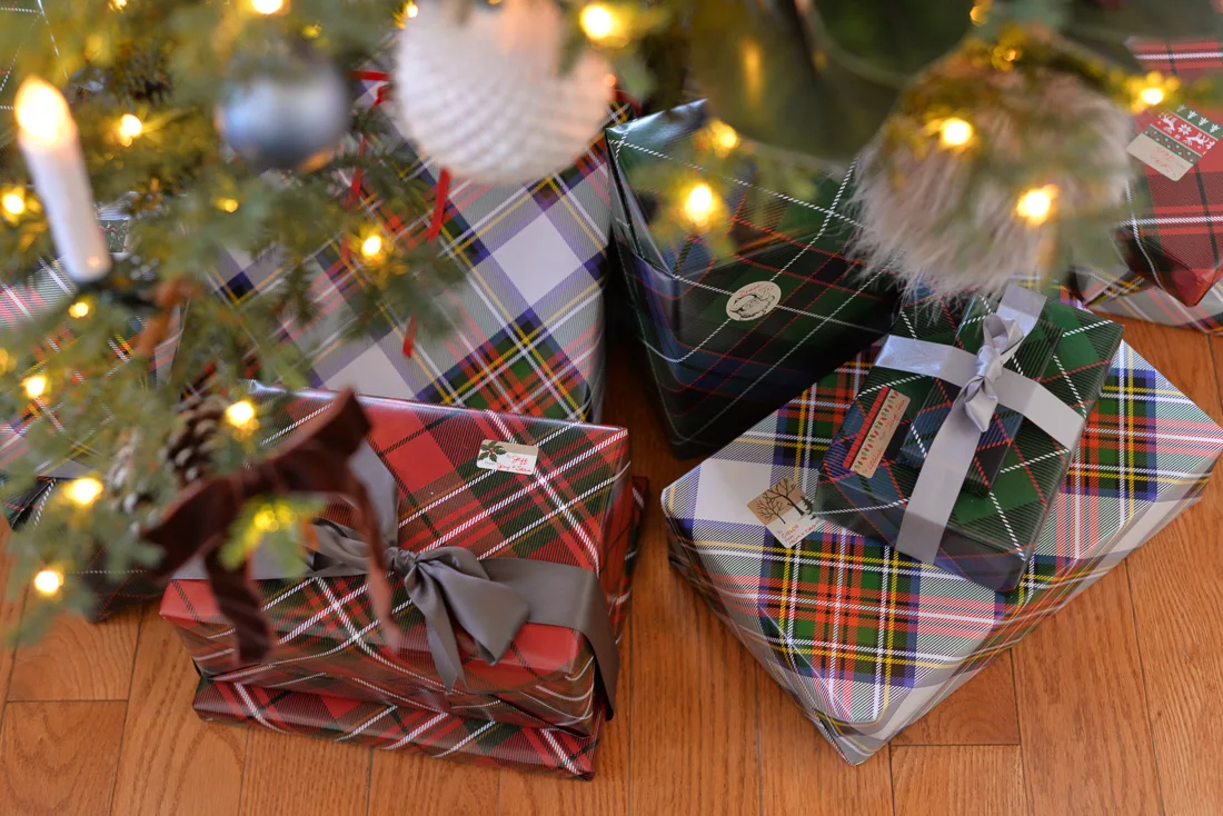plaid gift wrap christmas gifts under artificial tree