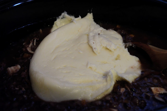 The  creamy thickener being added to the crock pot.