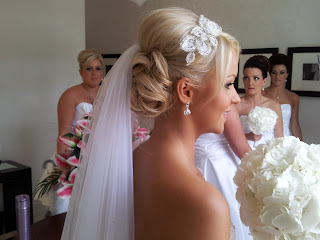 Blonde bride with low veil behind wedding hairstyle and leaf detail headpiece 