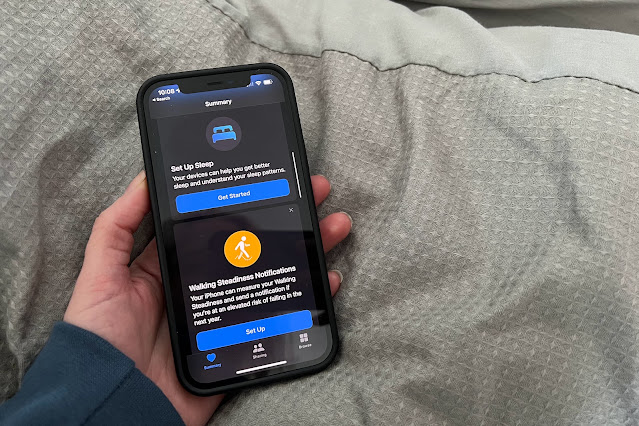 A hand holding an iphone set up to show the sleep section in the apple health app