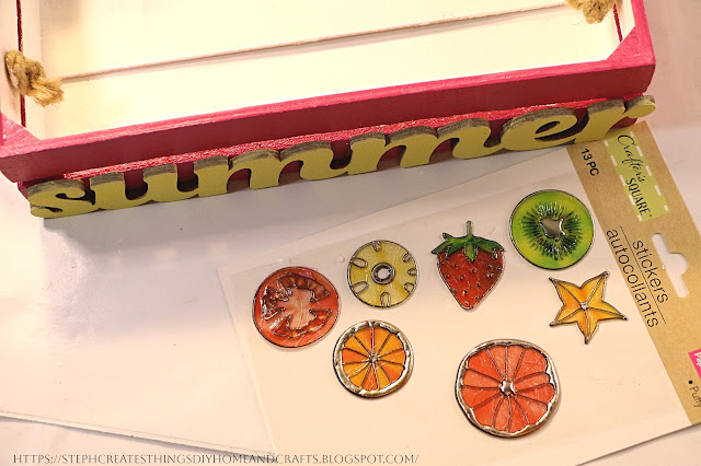 Wooden tray and fruit stickers on a table