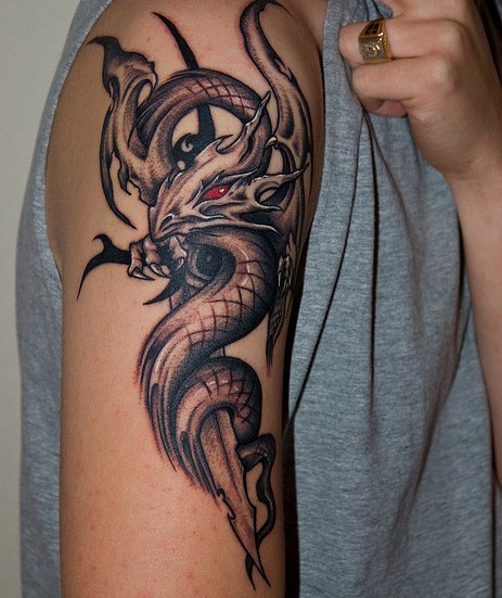 Tattoos Of Tribal Eyes. Tribal Dragon tattoo with red